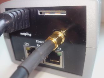 Installed SIM card in the slot of a NetPing 2 PWR-220 v2 SMS device
